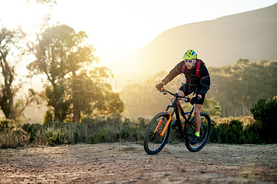 Buy stock photo Man, cycling and nature with mountain bike for fitness, extreme sport or outdoor exercise. Active, male person or cyclist riding with bicycle or helmet for adrenaline, cardio or workout on dirt road