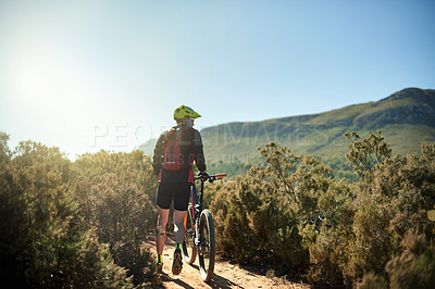 Buy stock photo Man, walking and bicycle on mountain for fitness, journey and travel break on trail. Back, athlete and bike on nature path for landmark search, explore track and enjoy view at sky space in Australia