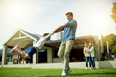 Buy stock photo Outdoor, family and father swinging kid in home garden for bonding, connection and fun together. Happy, love and dad spinning and playing with girl child on weekend in backyard of house in summer.