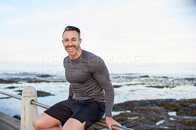 Buy stock photo Happy man, portrait or exercise break at beach for outdoor running, fitness workout or training space. Confident, mockup or male runner with smile at sea for wellness, resting or sports performance
