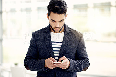 Buy stock photo Man, phone and texting at startup with app for contact, notification or networking at media company. Person, smartphone and scroll at office with proposal, deal and web chat at creative agency