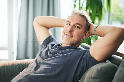 Buy stock photo Happy man, portrait and relief on couch in home, pride and confidence with rest in living room. Mature person, relax and smile for break on sofa, comfort and chill in lounge at apartment in Portugal