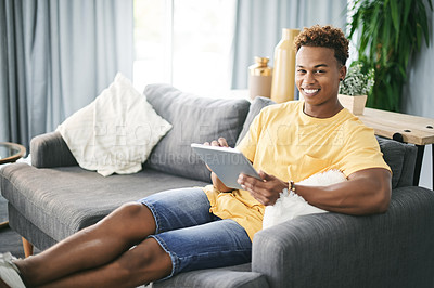 Buy stock photo Portrait, smile and tablet with man on sofa in living room of home to search for social media review. App, break and relax with happy African person reading information online for me time planning