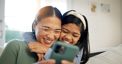 Buy stock photo Phone, mother and child on sofa with hug, laugh and love connection for social media browsing. Asian family, happy mom or kid in home with embrace, relationship affection or online reels with bonding