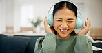 Headphones, music or asian woman in home for audio streaming, subscription or entertainment app. Happy, female person or listening with smile, sound or network connection for weekend podcast in house
