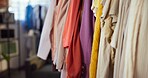 Clothing, line or rack in boutique store for garment selection, outfit choice or styling options. Empty, material or fashion with colorful costume or items on rail for fabric shopping in fitting room