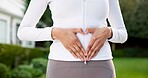 Fitness, woman and outdoor with heart hands for wellness, healing and gut health with cardio. Exercise, emoji and person with endometriosis in backyard, core support and uterus care for cramp relief