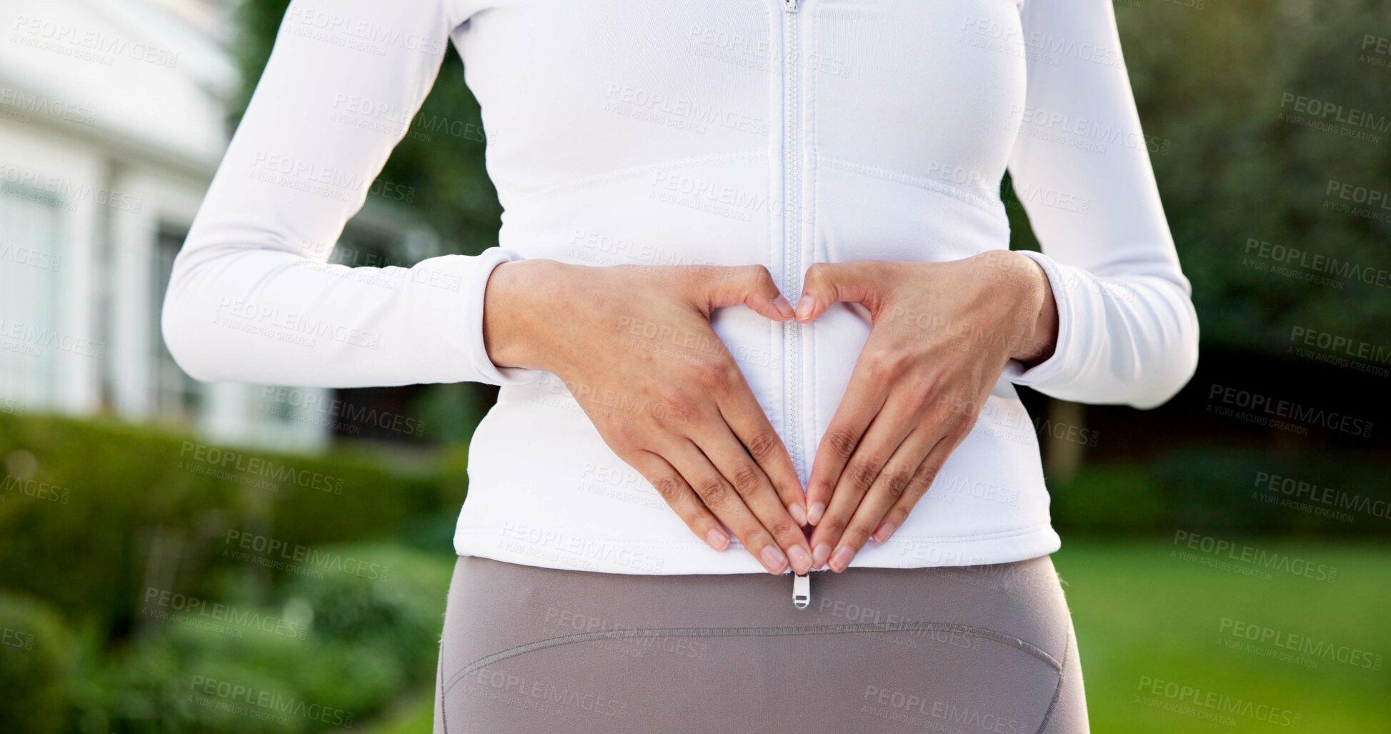 Buy stock photo Fitness, woman and outdoor with heart hands for wellness, healing and gut health with cardio. Exercise, emoji and person with endometriosis in backyard, core support and uterus care for cramp relief