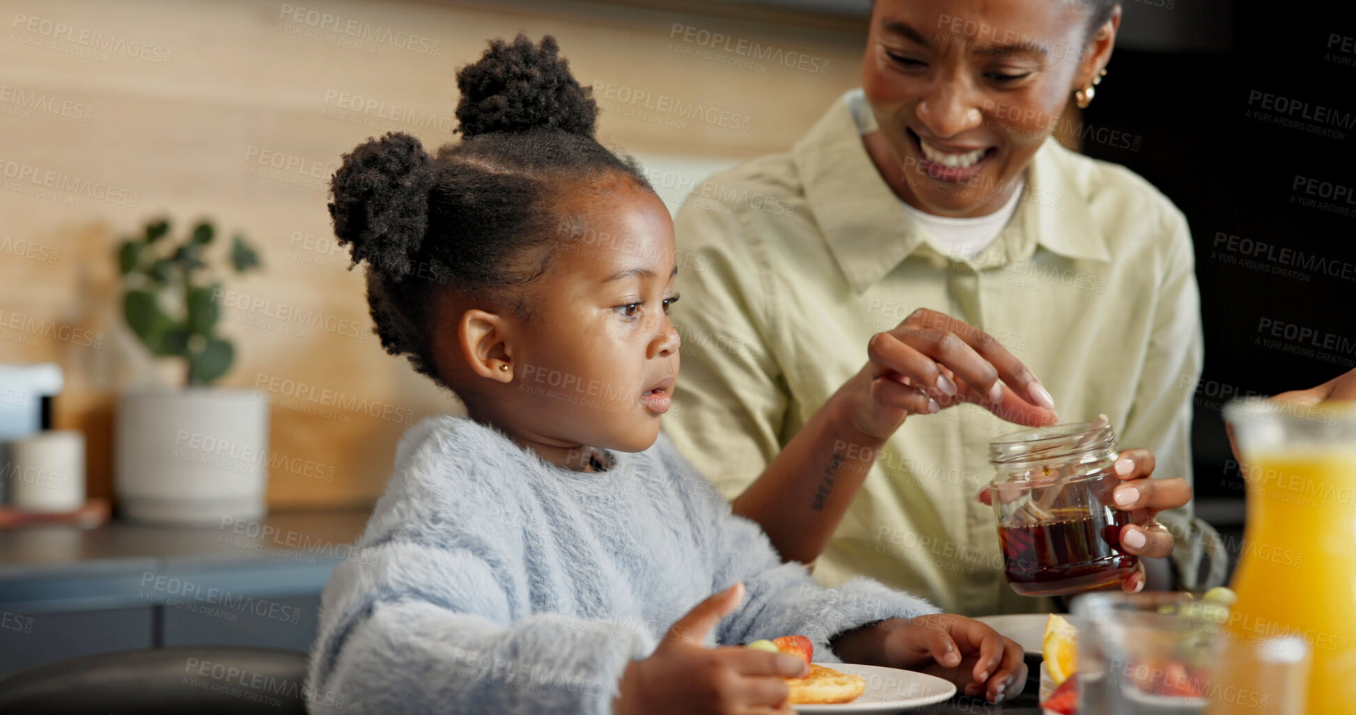Buy stock photo Eating, kitchen and mom with child for breakfast, healthy meal and morning routine for wellness. Family, food and African girl with mother, juice and honey for vitamins, growth and help in home