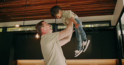 Buy stock photo Father, care and lift child in home with support, quality time and bonding together with smile. Happy boy, dad and play flying game in family house with love, fun and laughing with parent connection