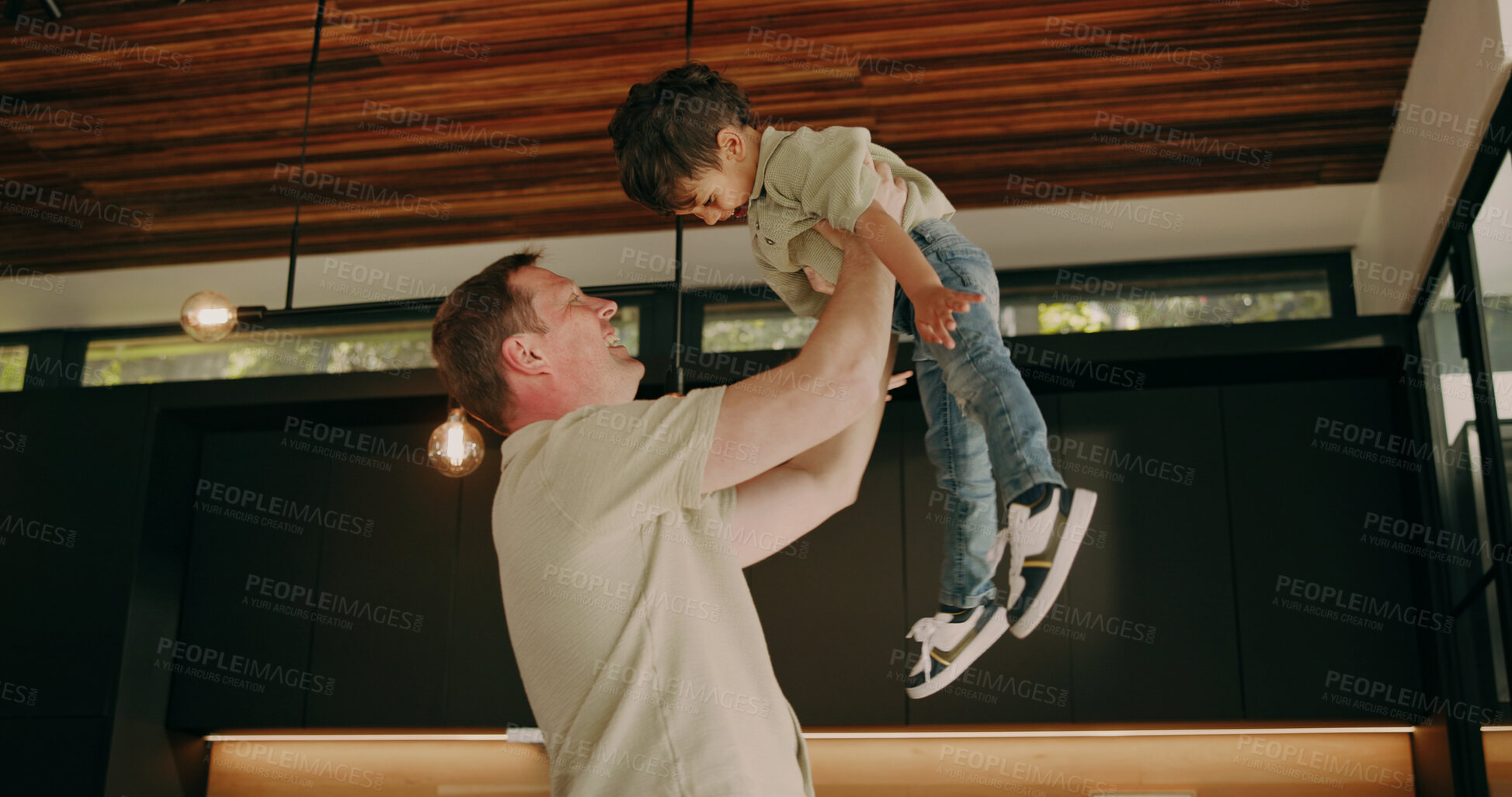 Buy stock photo Father, care and lift child in home with support, quality time and bonding together with smile. Happy boy, dad and play flying game in family house with love, fun and laughing with parent connection
