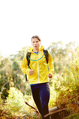 Buy stock photo Running, active and man with earphones, forest and listening to music for motivation, outdoor and speed. Nature, athlete and person with energy for sport, streaming or entertainment of radio in woods