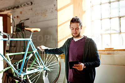 Buy stock photo Tablet, repair or man in bicycle shop to check inventory, wheel or research in small business. Reading, mechanic and owner with technology in store for maintenance update, online order or bike sales