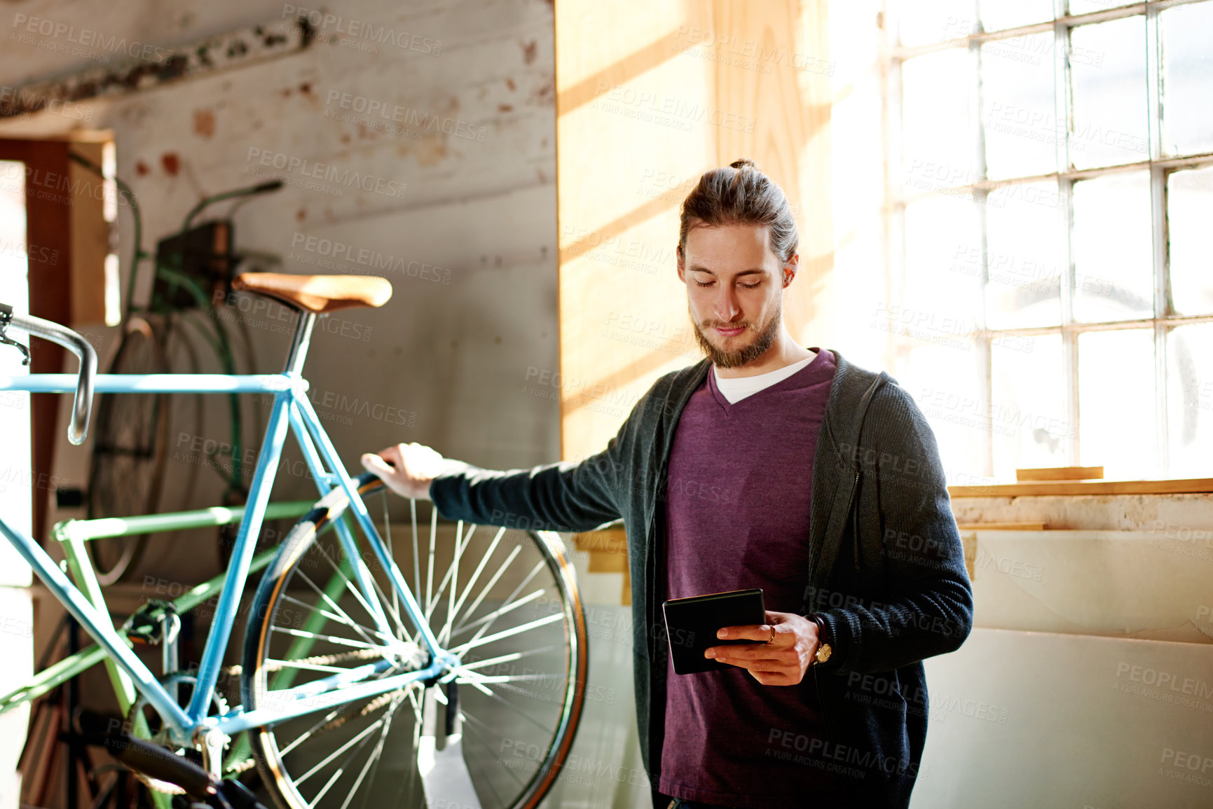 Buy stock photo Tablet, repair or man in bicycle shop to check inventory, wheel or research in small business. Reading, mechanic and owner with technology in store for maintenance update, online order or bike sales