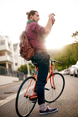Buy stock photo Tourism, photography or man on bike in city for holiday vacation or sightseeing memory. Social media, explore or tourist in urban town with bicycle for outdoor adventure, post or travel experience