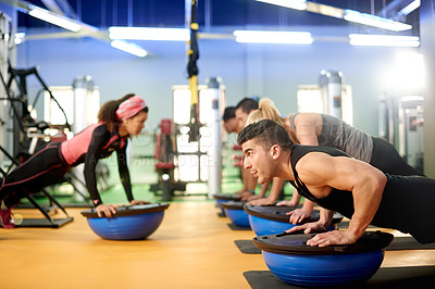 Buy stock photo Medicine ball, fitness and people with personal trainer in gym for core strength workout together. Push up, equipment and athletes with health coach for balance training with wellness in sport center