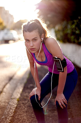 Buy stock photo Girl, exercise and break with earphones outdoor, portrait for rest and tired from running with music for teenager. Podcast, radio and streaming with female runner in street, recover and breathing