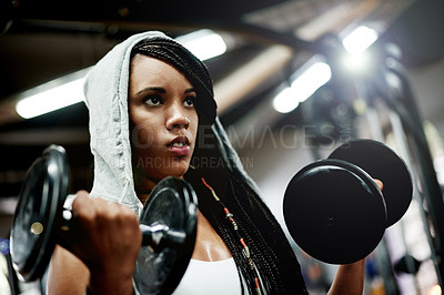 Buy stock photo Athlete, woman and dumbbells for fitness at gym for exercise, intense training and weightlifting. African female person, equipment and power workout with bodybuilder, strong muscles and health club