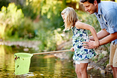 Buy stock photo Father, child and teaching with fishing net in river for learning, demonstration or holiday adventure. Family activity, dad and girl catch fish in lake with protection, summer vacation or development