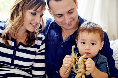 Buy stock photo Toys, portrait and parents with toddler on sofa in home for bonding, connection or family. Love, care and boy child with mother and father for sensory development in living room together at house.