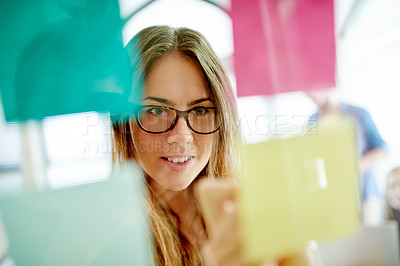 Buy stock photo Writing, business and woman in office with sticky note, planning and idea to develop strategy. Thinking, smile and marketer in creative agency with solution for campaign, media schedule and selection