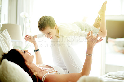 Buy stock photo Playing airplane, parent and child on bed with smile, love and connection for bonding together. Happy, mother and son in home with support, relationship building and fun flying game on weekend break.