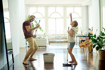 Buy stock photo Fun, dad and child in apartment to sing, dance and mop for weekend chores. Energy, family or music in living room with responsibility, hygiene and housework in learning or support for floor washing