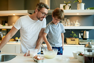 Buy stock photo Cooking, pancake and help with father and son in kitchen for learning, breakfast and support. Food, ingredients and batter with man and child with bowl in family home for teaching, bonding and love