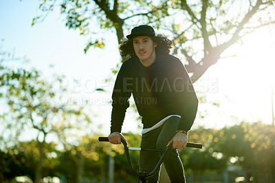 Buy stock photo Athlete, man and riding bicycle at park for travel, endurance training and cardio exercise. Person, cycling and bike for fitness activity, sports workout and sustainable transport for stunt practice