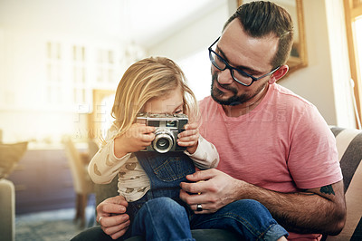 Buy stock photo Home, man and child with camera, pictures and bonding with daughter in lounge, vintage and learning. Family, happy and photography with retro tech, kid and hobby with dad, growth or skill development
