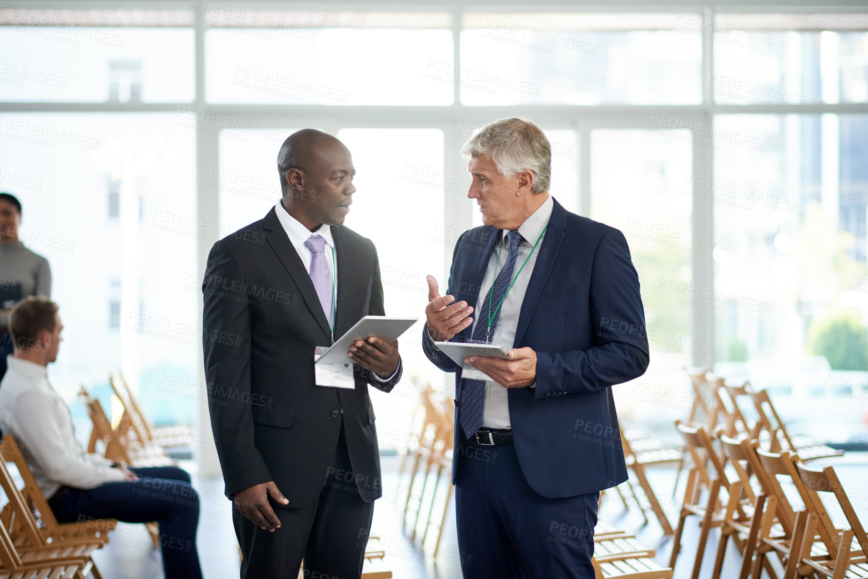 Buy stock photo Businessman, tablet and talk for networking at convention with app, introduction and schedule for meeting. People, exchange contact and tech for planning, calendar or chat at international conference