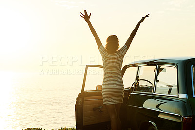 Buy stock photo Shot of a happy young woman enjoying a road trip