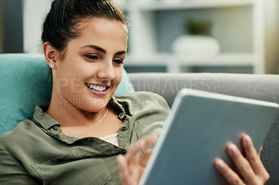 Buy stock photo Happy, woman and relax with tablet, lounge and reading ebook on website, browsing or online in home. Scroll, app and tech with fiction novel, break and person with smile for story or entertainment