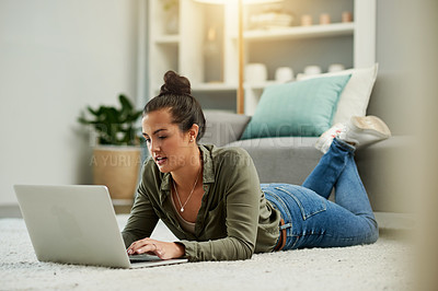 Buy stock photo Laptop, home and woman relax on floor for typing blog, online search or reading email. Computer, internet and girl on carpet in living room for browsing website, social media or check news with flare
