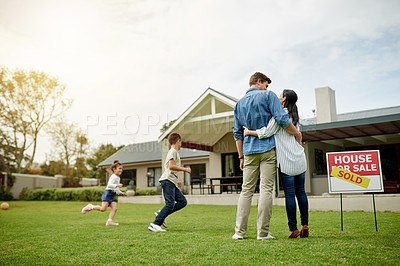 Buy stock photo Purchase, real estate and new home for family, hug and milestone for homeowner with property and yard. Outdoor, relocation and people with investment of house, playing and parents with children