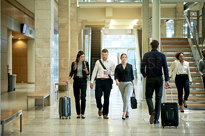 Buy stock photo Man, women and team on business trip in lobby with luggage, smartphone and happy for travel at airport. People, group and walk with smile, coffee and suitcase with mobile app for flight schedule