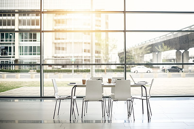 Buy stock photo Desk, chairs and empty office with boardroom for meeting with interior for corporate company. Table, furniture and business presentation in conference room in building with coffee and laptop.
