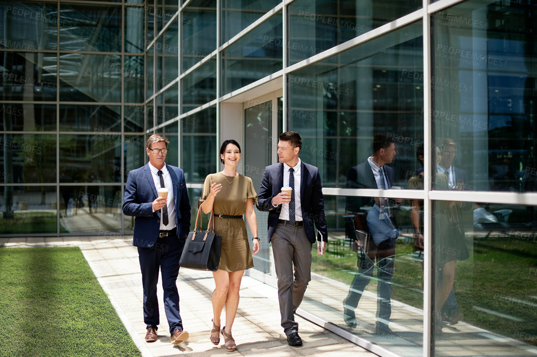 Buy stock photo Outdoor, business people or walking with smile by glass office, conversation or commute to work. Happy, colleagues or travel to workplace with discussion, friendship or commitment in corporate career