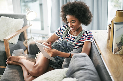 Buy stock photo Smile, home and black woman on sofa, tablet and texting with subscription, email and relax. Happy, apartment and African person on couch, tech or internet with connection, digital app or social media