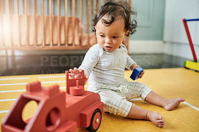 Buy stock photo Toy truck, baby and play in home, having fun and relaxing in nursery of house alone. Development, childhood and playful, carefree and kid, infant or newborn playing with block, red car or learning