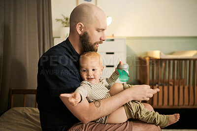 Buy stock photo Children, clothing and a father dressing his baby in pajamas in the nursery of their home for bedtime. Family, kids and a young male parent changing the clothes of his infant child in the house