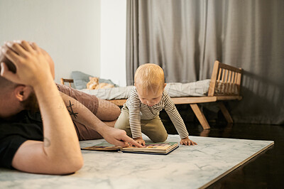 Buy stock photo Reading book, child and father in a family home bedroom for development. Man or dad with baby or kid on floor for quality time, love and care or learning, talking and together for story or question