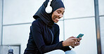 Headphones, fitness or muslim woman with phone outdoor, listen to radio or streaming song with smile. Hijab, happy runner and black person with mobile, music and audio break  with podcast in city