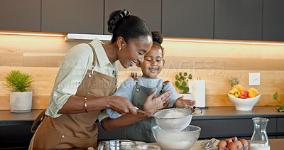 Buy stock photo Mother, kid and baking in kitchen with sieve, teaching daughter and support with happiness. Black family, parent and girl flour sifting at home for learning, culinary skill development and help