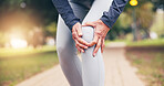 Elderly, person and hands with knee pain in park for outdoor injury, accident or overworked strain. Active, senior or sore leg with joint inflammation for muscle tension, mistake or fall in nature