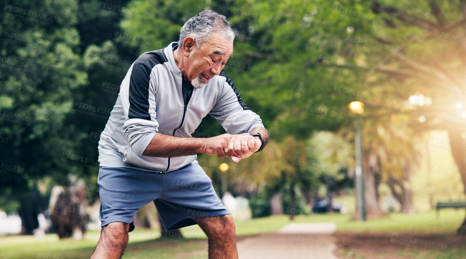 Buy stock photo Senior, man and checking time with watch in park for outdoor fitness or tracking performance. Elderly, male person or wristwatch with heart rate for monitoring cardio, health or wellness in nature