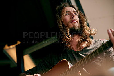 Buy stock photo Man, play guitar and thinking in home, creativity and low angle with talent for songwriting process. Person, musician and artist with string instrument, perspective or inspiration with sound at house