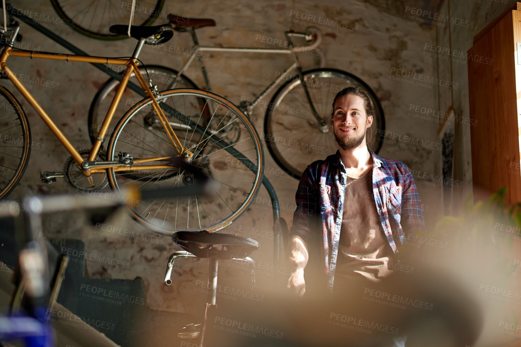 Buy stock photo Man, thinking and smile with bicycle, shop and reflection with small business owner in garage. Person, entrepreneur and mechanic for sustainable company, inspiration or bike restoration at workshop