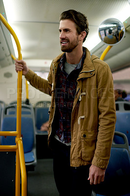 Buy stock photo Man, smile and thinking on bus for travel, daily commute and urban journey in morning. Passenger, standing and commuter on public transport for trip, schedule and happy for metro service in city