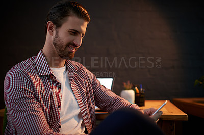 Buy stock photo Night, creative man and phone in office for contact, networking and social media on work break. Designer, mobile and smile in agency for project feedback, deadline extension and research on internet
